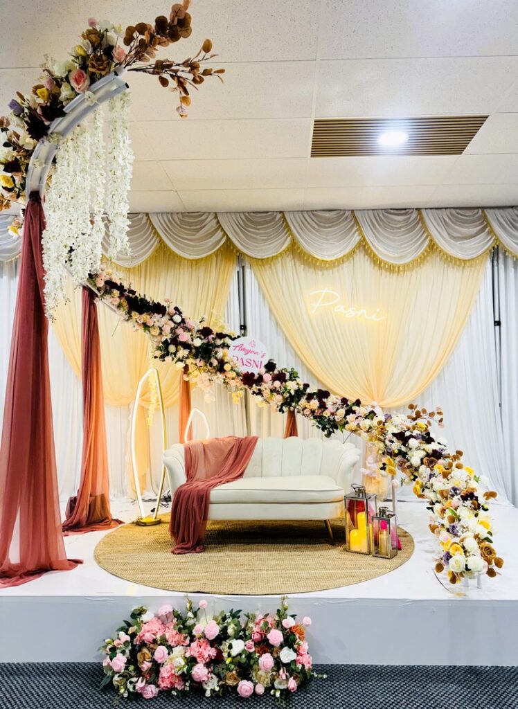 Luxurious Pasni/Annaprashan/Baby weaning ceremony stage decoration with floral arch and drapery by Saraya D Decor Adelaide