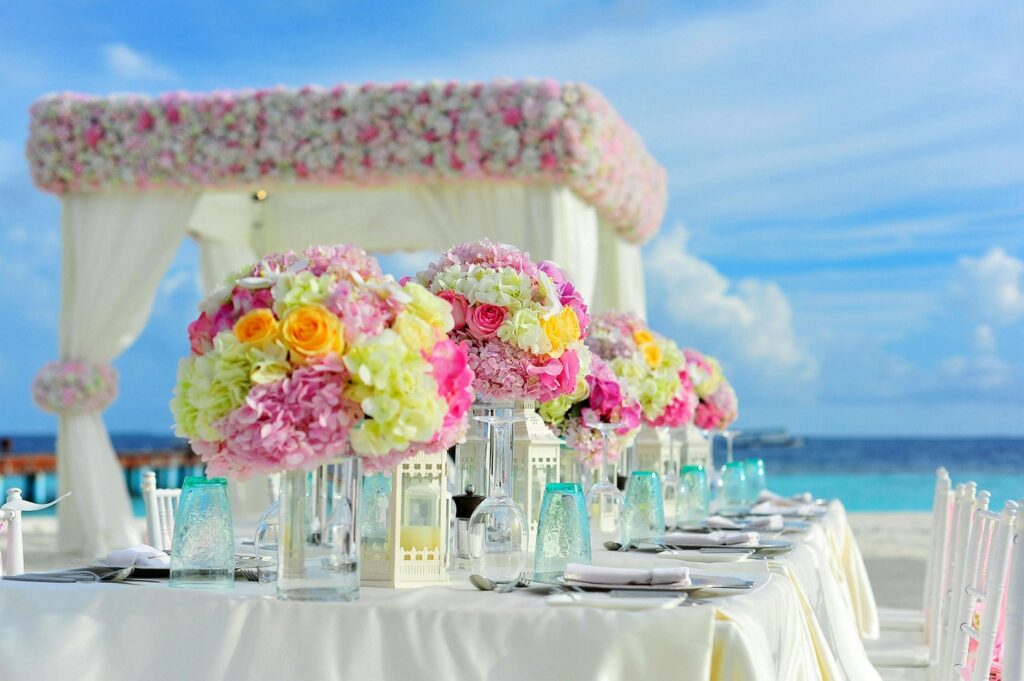 Oceanfront wedding tablescape with pastel floral arrangements by Saraya D Decor Adelaide