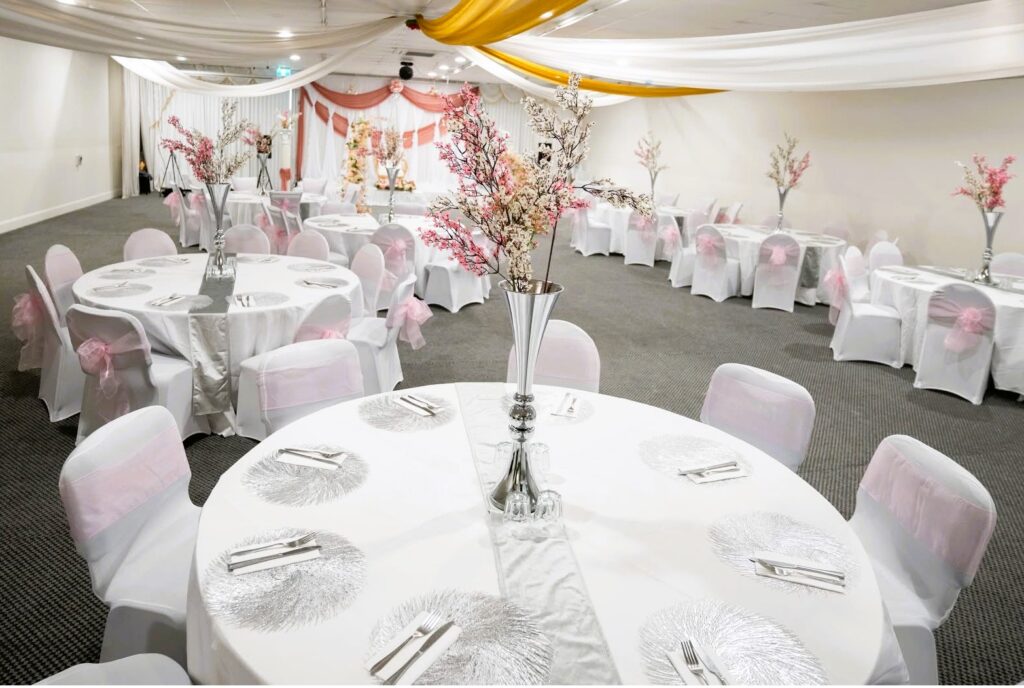Elegant wedding and event hall decoration with pink floral centerpieces by Saraya D Decor Adelaide