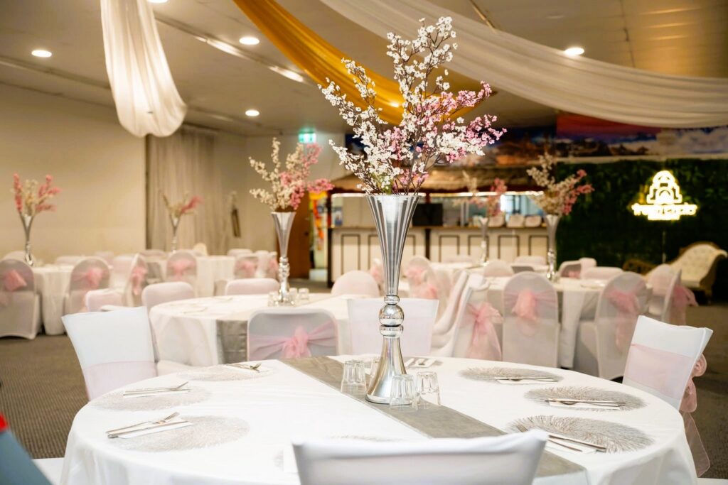 Round table decoration with tall silver floral vases by Saraya D Decor Adelaide