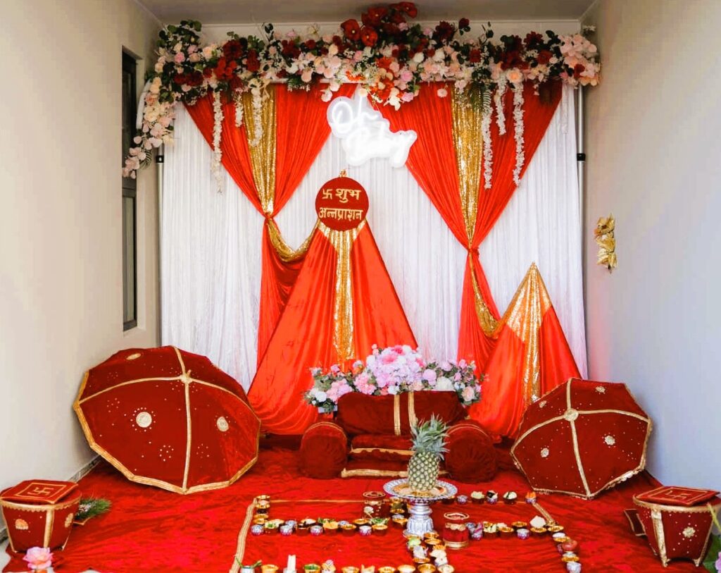 Traditional red and gold Pasni stage setup with cultural props by Saraya D Decor Adelaide